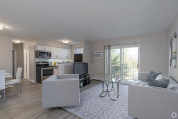 Pottstown apartment for rent - A modern living room with a grey sofa and a television.