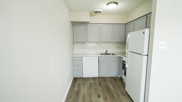 Philadelphia apartment for rent - A white kitchen with a refrigerator, sink, and cabinets.