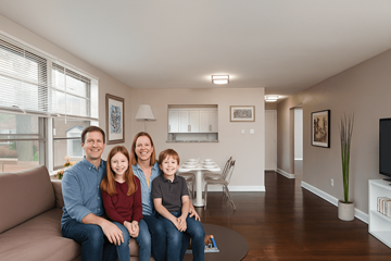 Pottstown apartment for rent - A family of four is sitting on a couch in a living room.