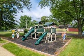 Pottstown apartment for rent - Kids running around a playground at Pottstown's Arbor Grove
