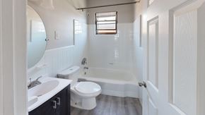 Philadelphia apartment for rent - A white bathroom with a toilet, sink, and bathtub.
