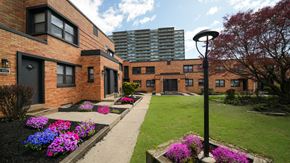 Philadelphia apartment for rent - A brick building with a green lawn in front.