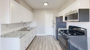 Philadelphia apartment for rent - A kitchen with a stove, sink, and cabinets.