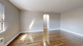 Philadelphia apartment for rent - A room with wooden floors and a doorway leading to another room.