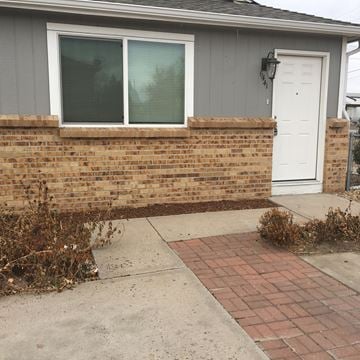 Westminster triplex for rent - A house with a white door and a brick wall.