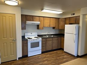 Fort Morgan townhouse for rent - an empty kitchen with white appliances and wooden cabinets