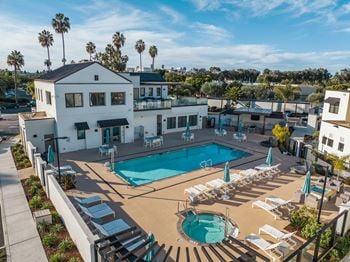 Spacious pool deck with heated pool & spa, cabana, bbq, and lounge seating