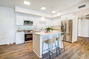 Goleta apartment for rent - A kitchen with a white island and a refrigerator.