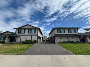 Huntington Beach apartment for rent - A row of houses with a flag on the right.