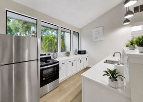 Tampa apartment for rent - A modern kitchen with a stainless steel refrigerator and white cabinets.
