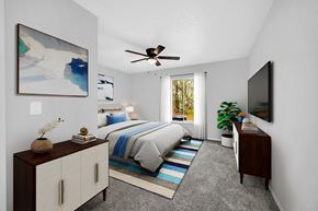 Orlando apartment for rent - a bedroom with a bed and a ceiling fan at Southern Oaks Residences