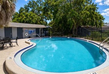 Clearwater apartment for rent - A small pool with a white border and a black fence.