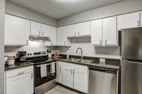 Nashville apartment for rent - a kitchen with stainless steel appliances and white cabinets at The Highland on Briley in Nashville, TN