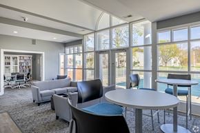 Jackson apartment for rent - A room with a table and chairs with a view of a pool outside.