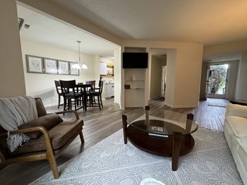 Jackson apartment for rent - A living room with a brown chair and a glass coffee table.