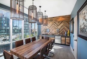 Nashville apartment for rent - a dining room with a long wooden table and chairs and large windows