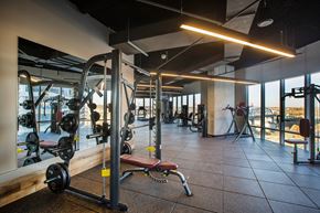 Nashville apartment for rent - a gym with weights machines and a view of the city