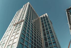 Atlanta apartment for rent - looking up at two tall skyscrapers with a blue sky behind them at Scout Living, powered by Placemakr Apartments, Atlanta, GA