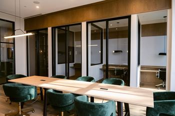 Long conference room with table and chairs