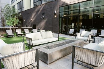 Patio with firepit and white chairs