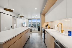 Salt Lake apartment for rent - A modern kitchen with wooden cabinets and a white countertop.