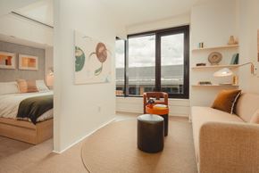 Atlanta apartment for rent - a living room with a large window and a couch and a chair at Scout Living, powered by Placemakr Apartments, Atlanta, GA