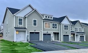 Chambersburg apartment for rent - a gray house with two garage doors and a driveway