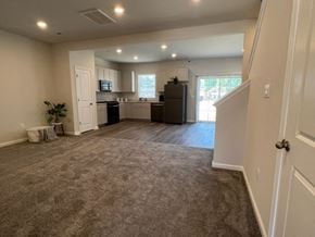 Chambersburg apartment for rent - an empty living room and kitchen with a carpeted floor