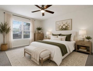 Hagerstown apartment for rent - A bedroom with a large bed and a ceiling fan.