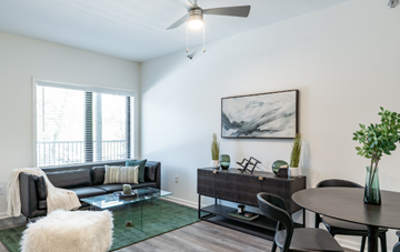 Detroit apartment for rent - A living room with a couch, chairs, and a painting on the wall.