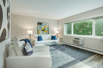Wauwatosa apartment for rent - a living room with white furniture and a large window