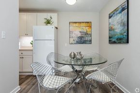 Wauwatosa apartment for rent - a dining room with a table and chairs and a refrigerator