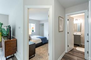Wauwatosa apartment for rent - a bedroom and a bathroom with a bed and a mirror