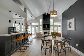 Jacksonville apartment for rent - A modern dining room with a bar area and a large window.