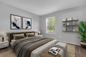 Indianapolis apartment for rent - A bedroom with a large bed and two framed pictures on the wall.