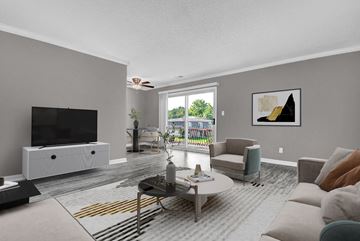 Indianapolis apartment for rent - A living room with a television, a white cabinet, a grey sofa, a coffee table, and a painting on the wall.