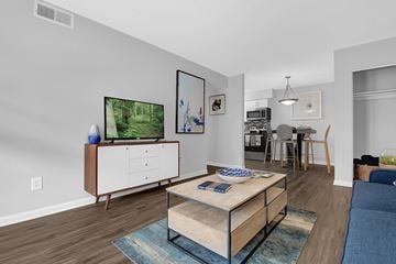 Lexington apartment for rent - A living room with a wooden coffee table and a television on a cabinet.
