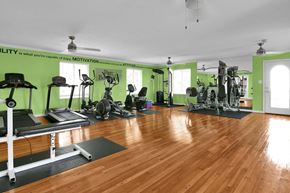 Indianapolis apartment for rent - A gym with a variety of equipment including treadmills, weights, and exercise machines.