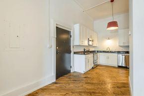 Knoxville apartment for rent - a kitchen with white cabinetry and black countertops