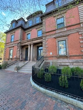 Portsmouth apartment for rent - the front of a brick building with stairs and a black fence