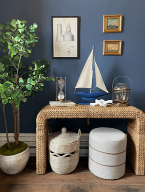 Portsmouth apartment for rent - a wicker bench with a sailboat and baskets in a blue walled room