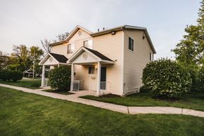 Grand Rapids apartment for rent - duplex with yellow siding and white trim grass