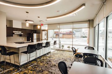 Grand Rapids apartment for rent - a large room with tables and chairs and a kitchen