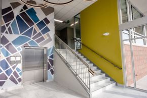 Grand Rapids apartment for rent - apartment entrance with yellow wall and mural