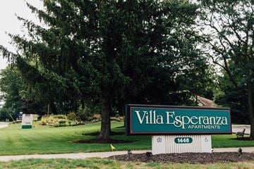 Wyoming apartment for rent - A sign for Villa Esperanza apartments is in front of a large tree.