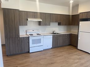 Mcminnvile apartment for rent - A kitchen with white appliances and wooden cabinets.