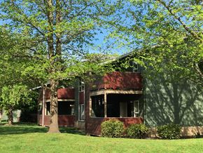 Mcminnville apartment for rent - A tree stands in front of a two-story house.