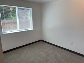 Newberg apartment for rent - A room with a window and carpeted floor.