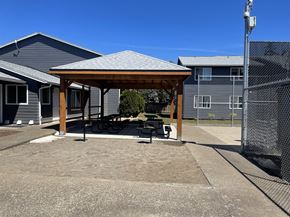 Newberg apartment for rent - A gazebo is situated in a concrete courtyard.