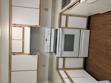 Mcminnville apartment for rent - A kitchen with white appliances and wooden cabinets.